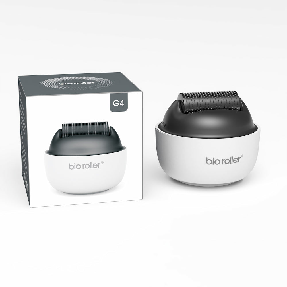 Bio Roller G4 microneedling-rodillo junto con el empaque del producto, diseñado para tratamientos faciales, rejuvenecimiento de la piel y mejora de la absorción del suero.