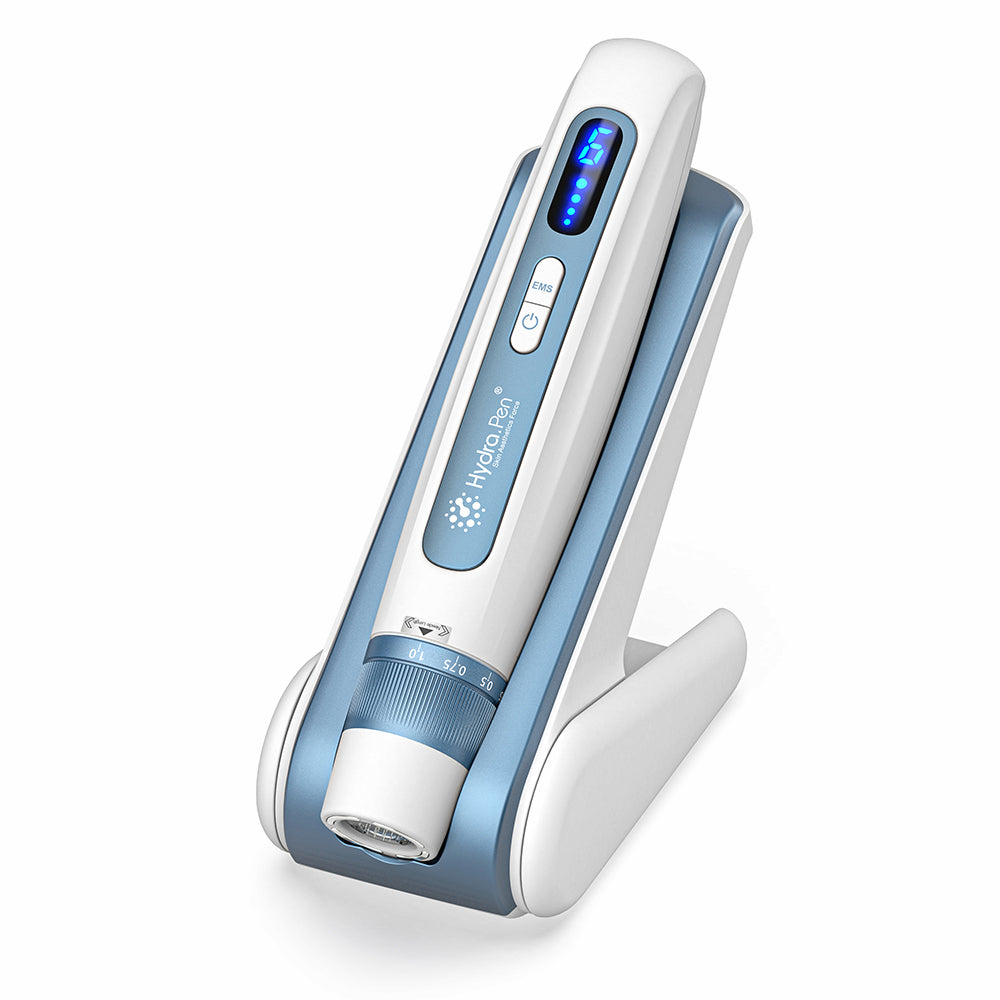 HydraPen H5 pluma blanca y azul microneedling de pie en su base de carga, dispositivo de microagujas avanzado para infusión de suero y tratamiento de la piel.